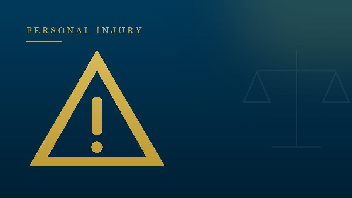 Gold warning triangle on navy — defective product liability